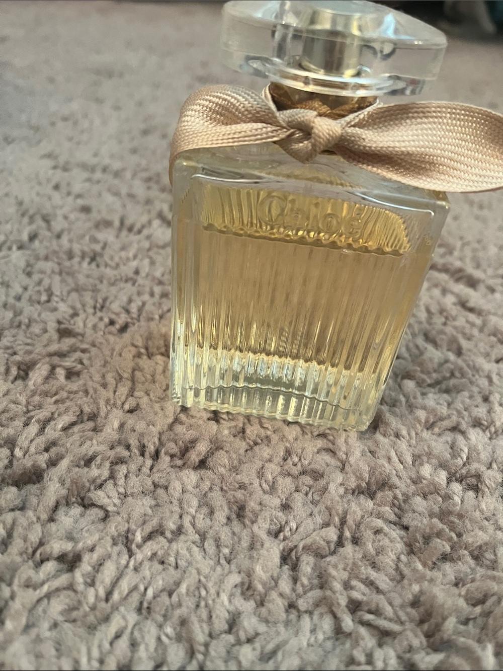 Chloe Perfume Bottle with Gold Ribbon and Pale Yellow Liquid